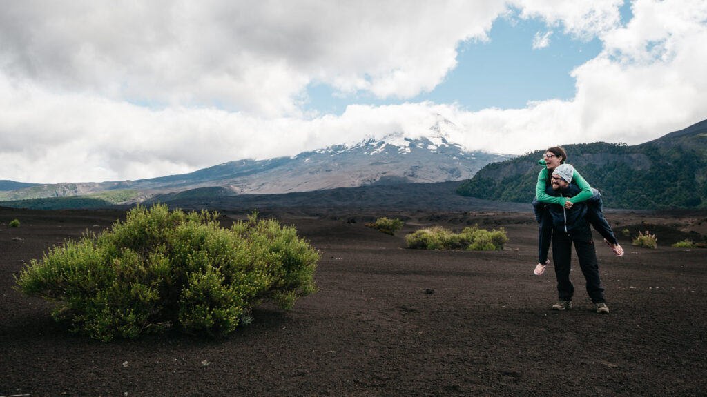 Chile Parque Nacional Conguillio Volcan Llaima-Bianca and Tom standing on lavastone