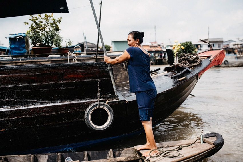 Cai Be Floating Market woman standing on boat