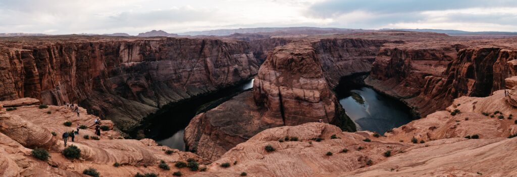 The Colorado River curving around Horseshoe Bend at sunset
