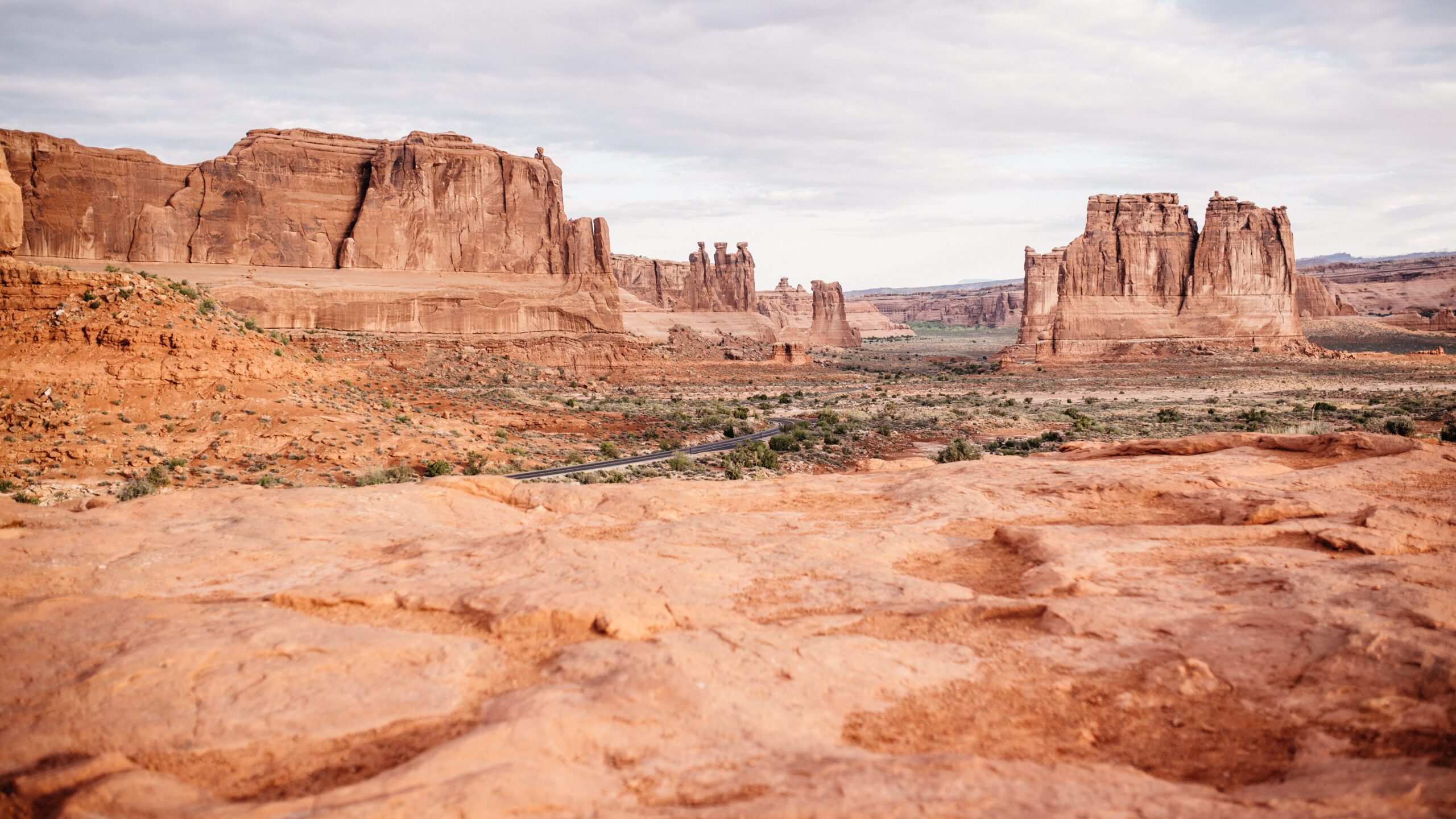 Red sandstone formations beside the road through Arches National Park