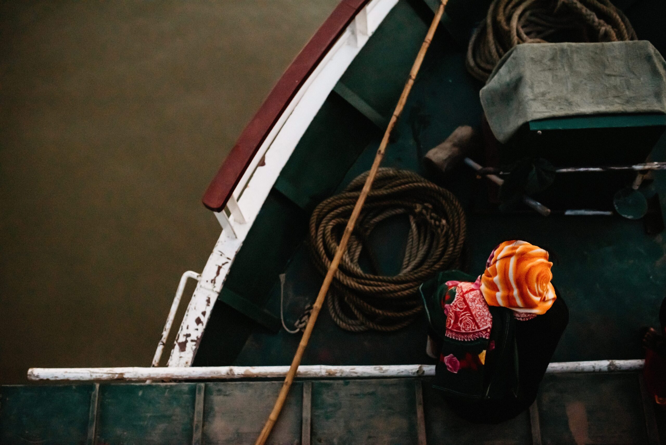 A crew member working at the bow of the boat on the Irrawaddy River