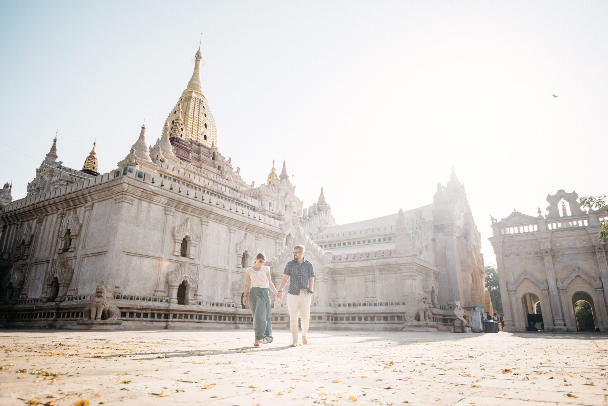 Visitors in the courtyard of a white temple in Bagan