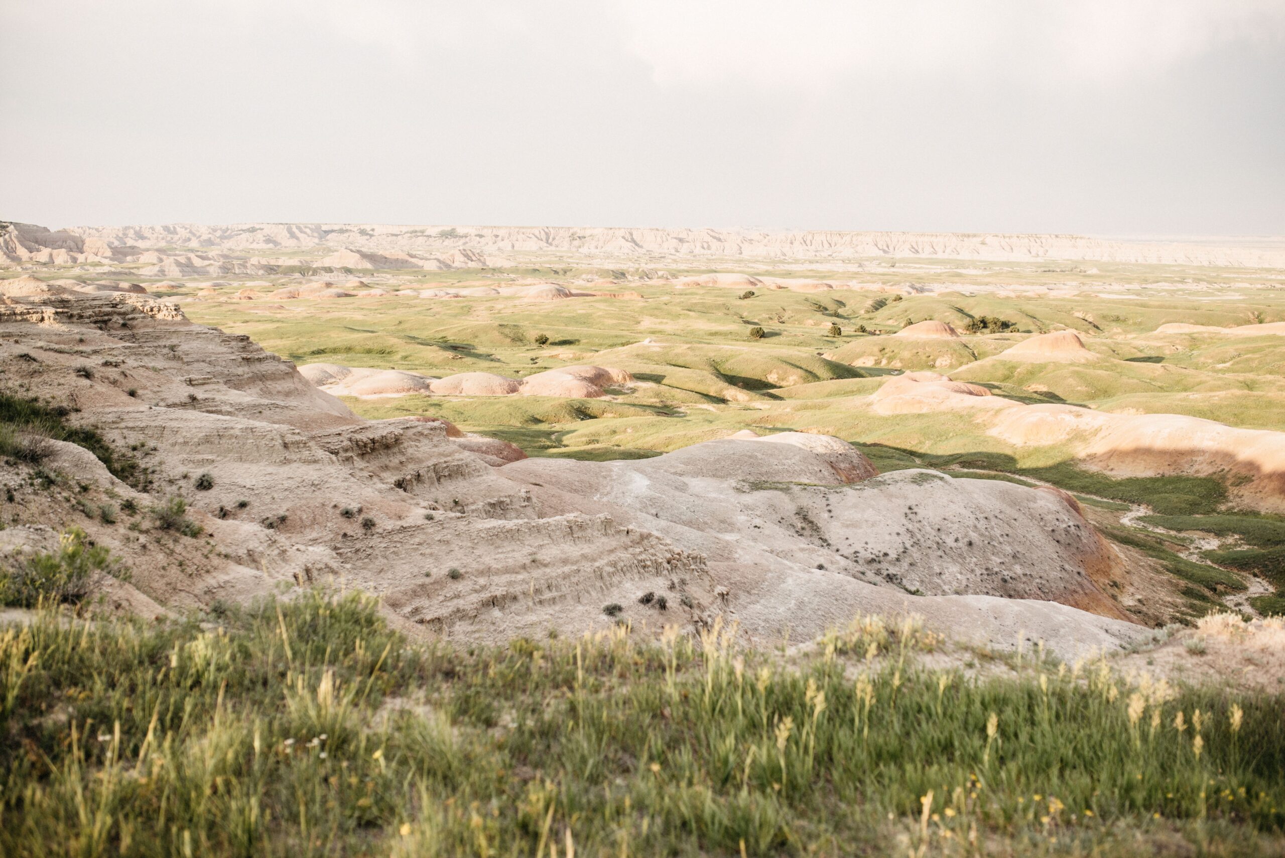 Striped rock formations and grass in Badlands National Park