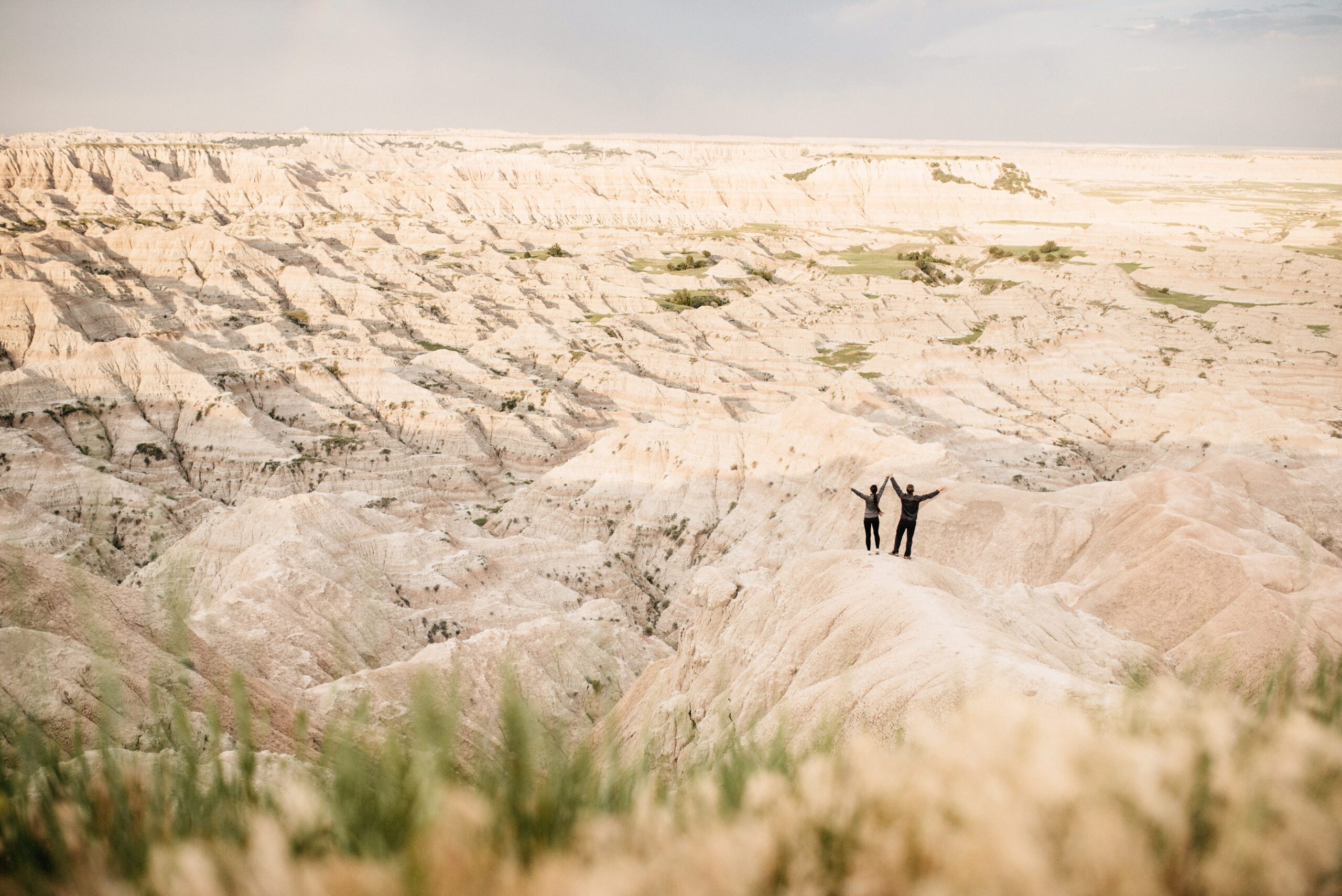 Bianca and Tom standing between pale Badlands ridges
