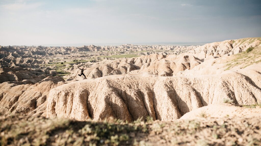 Tom standing among the eroded ridges of Badlands National Park