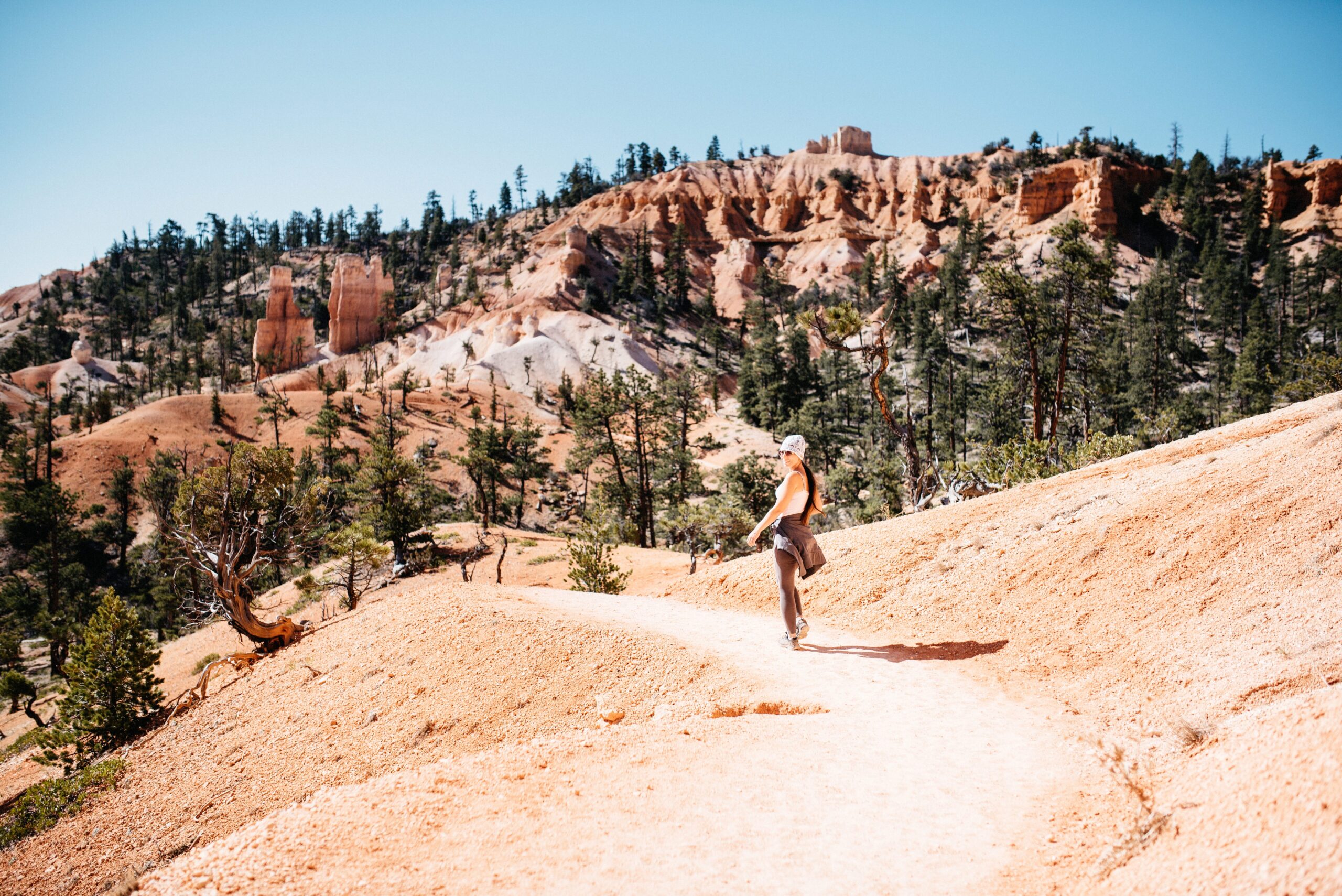 Bianca hiking through the open landscape of the Fairyland Loop
