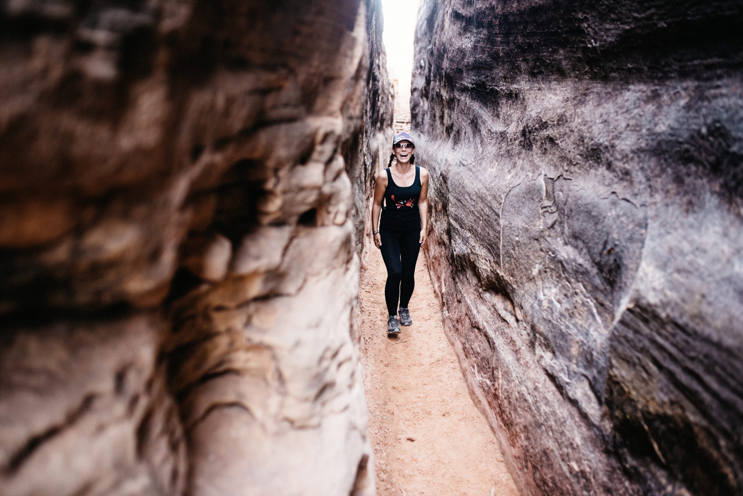 Bianca walking through a narrow slot on the Chesler Park Loop