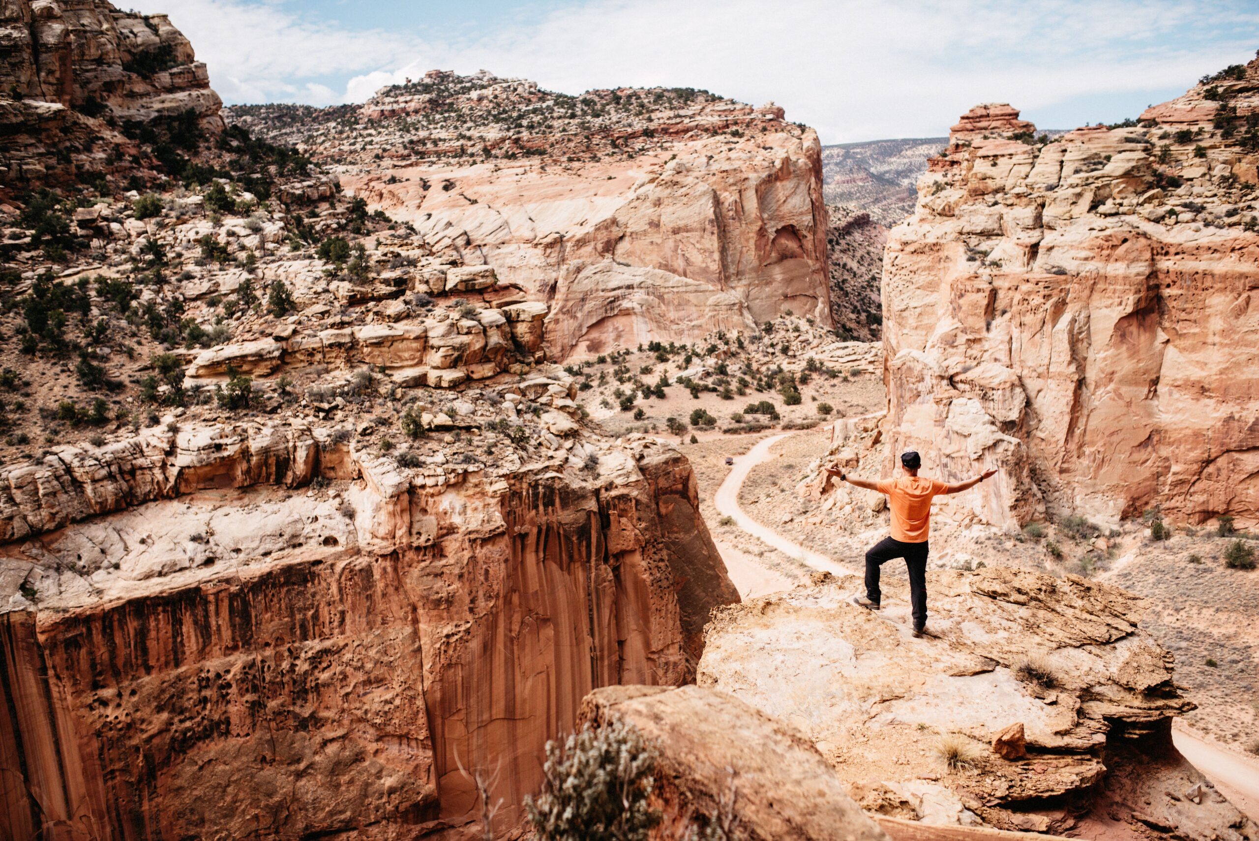 Tom standing above the canyon on the Cassidy Arch Trail