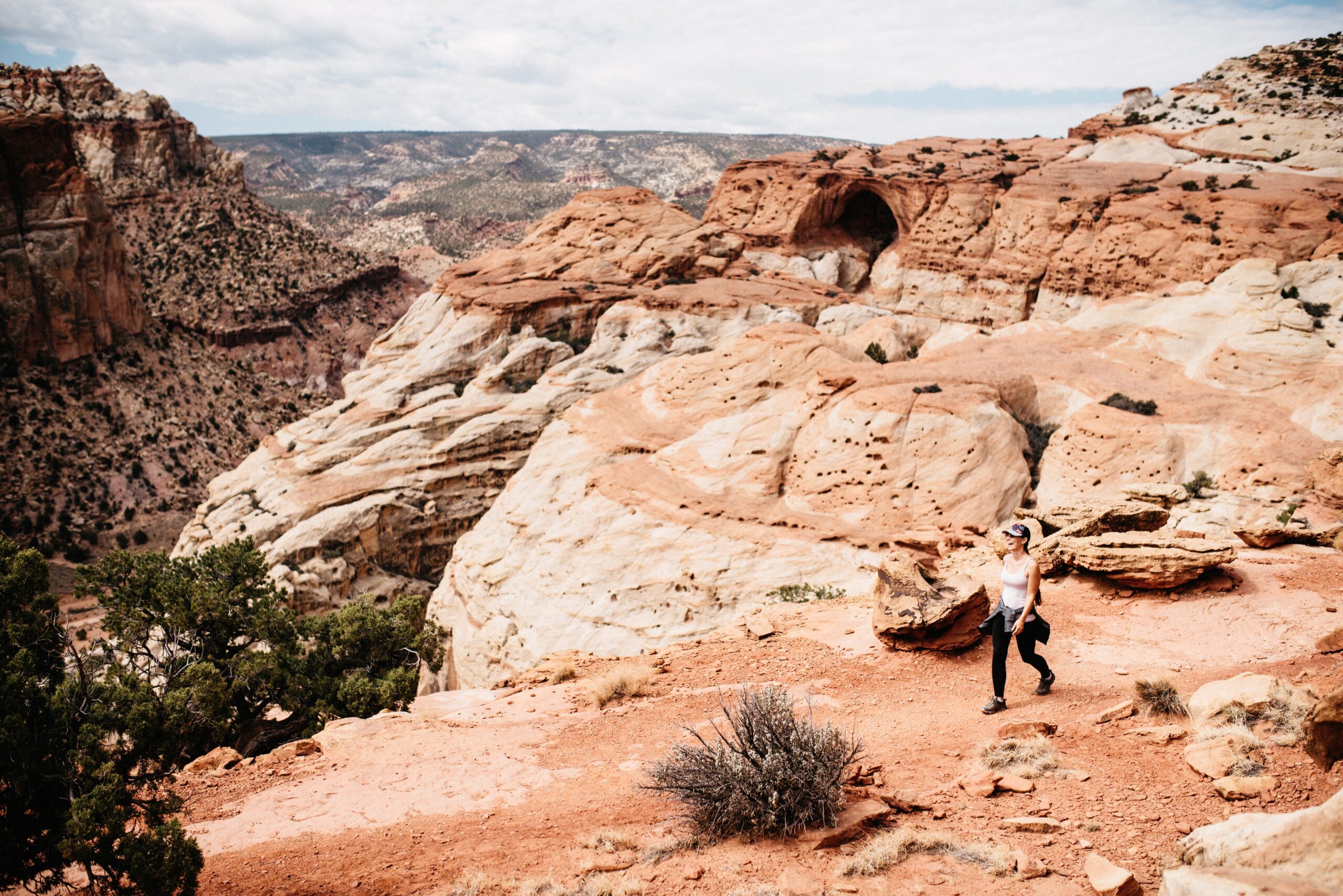 Bianca walking across the pale rock near Cassidy Arch