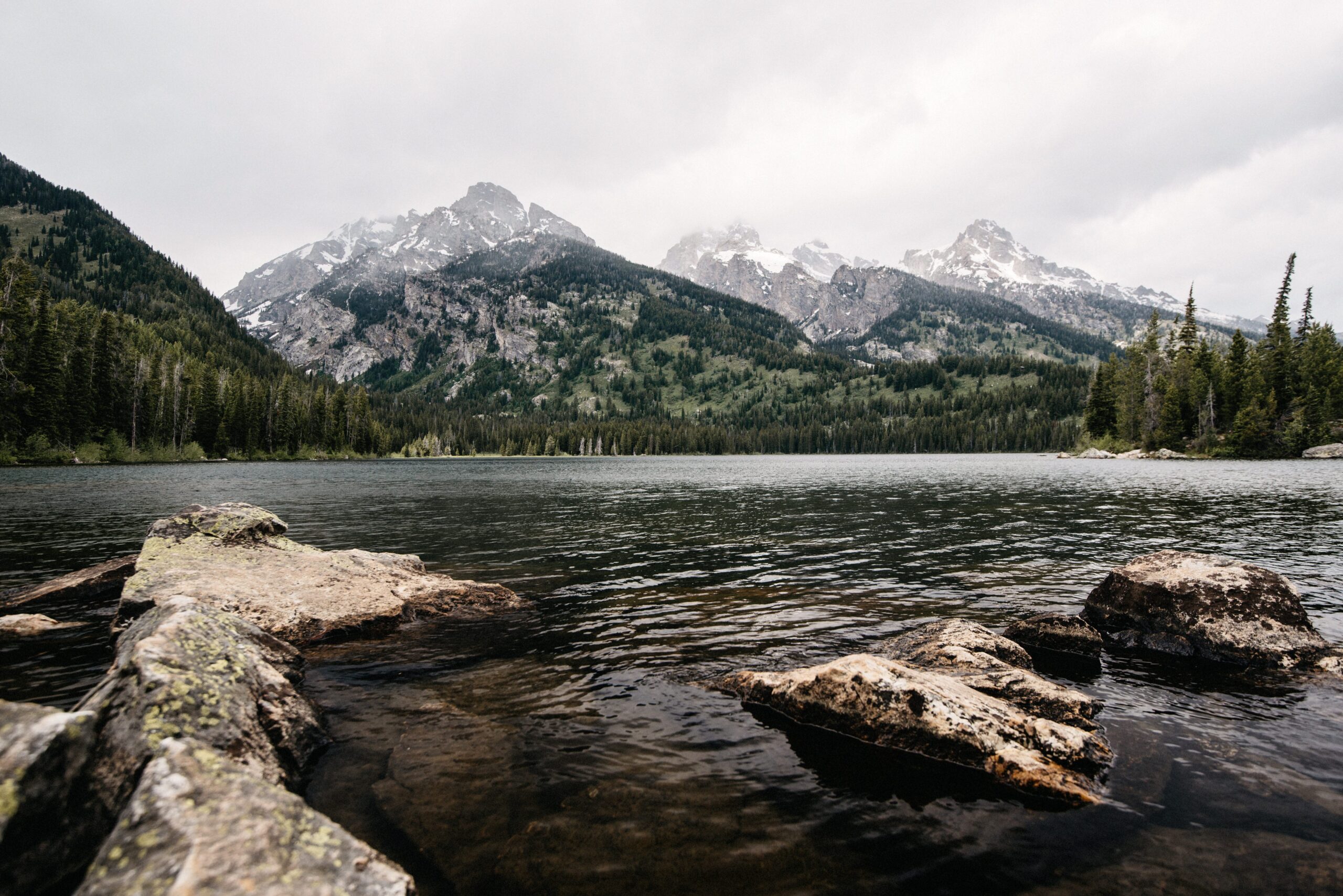 Taggart Lake surrounded by forest and mountains