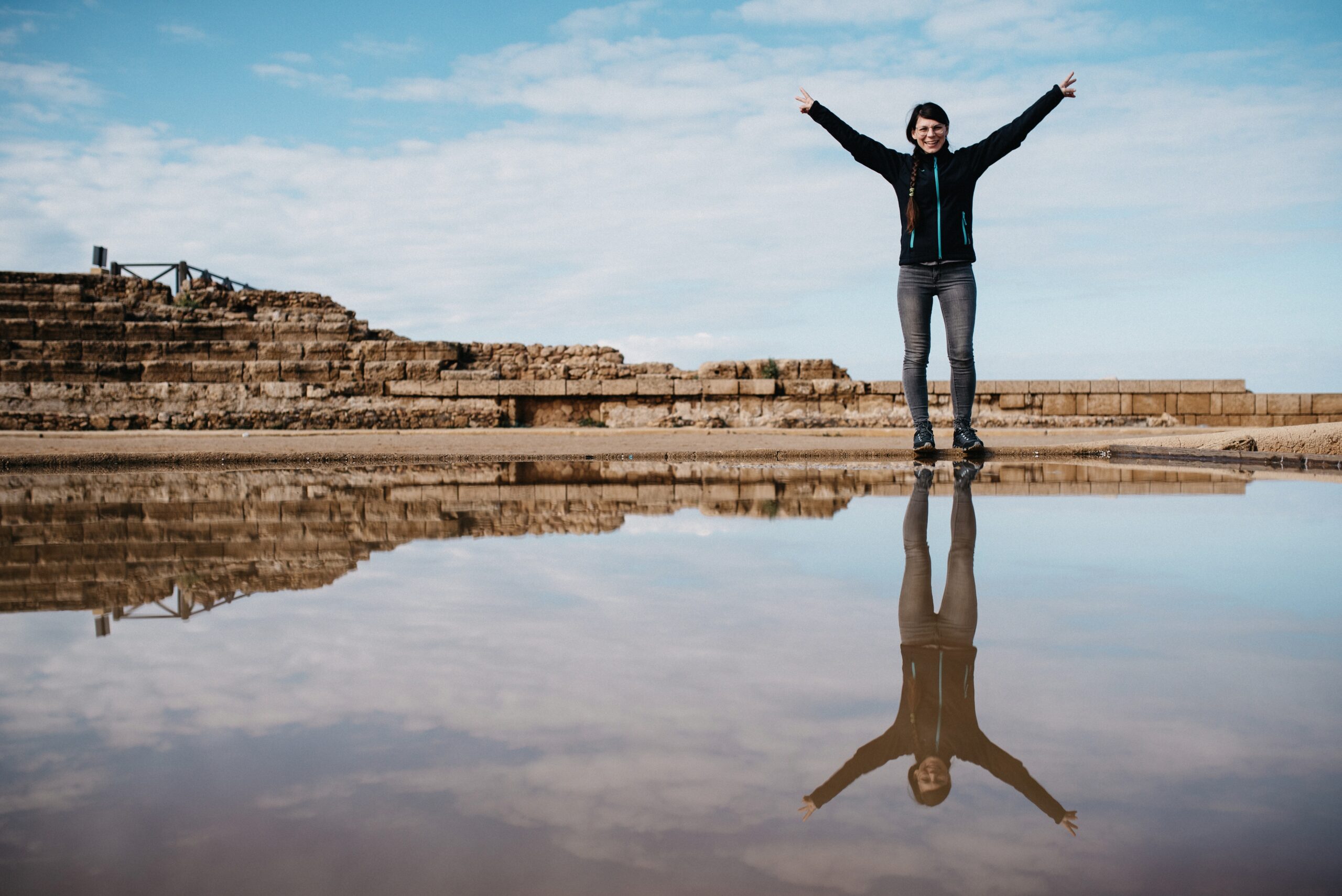 Bianca reflected in the shallow water beside the ruins at Caesarea