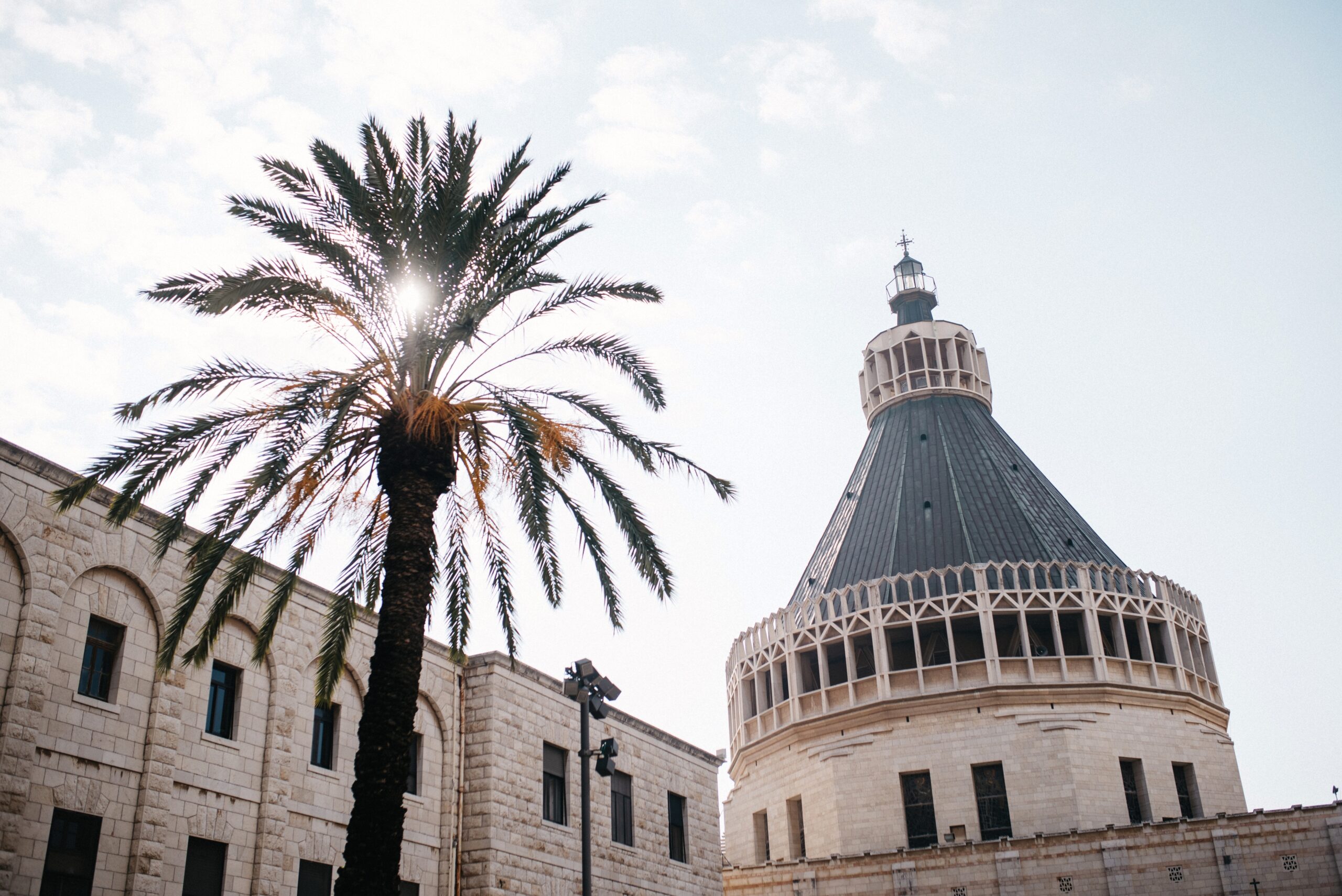 The Basilica of the Annunciation rising above palm trees in Nazareth