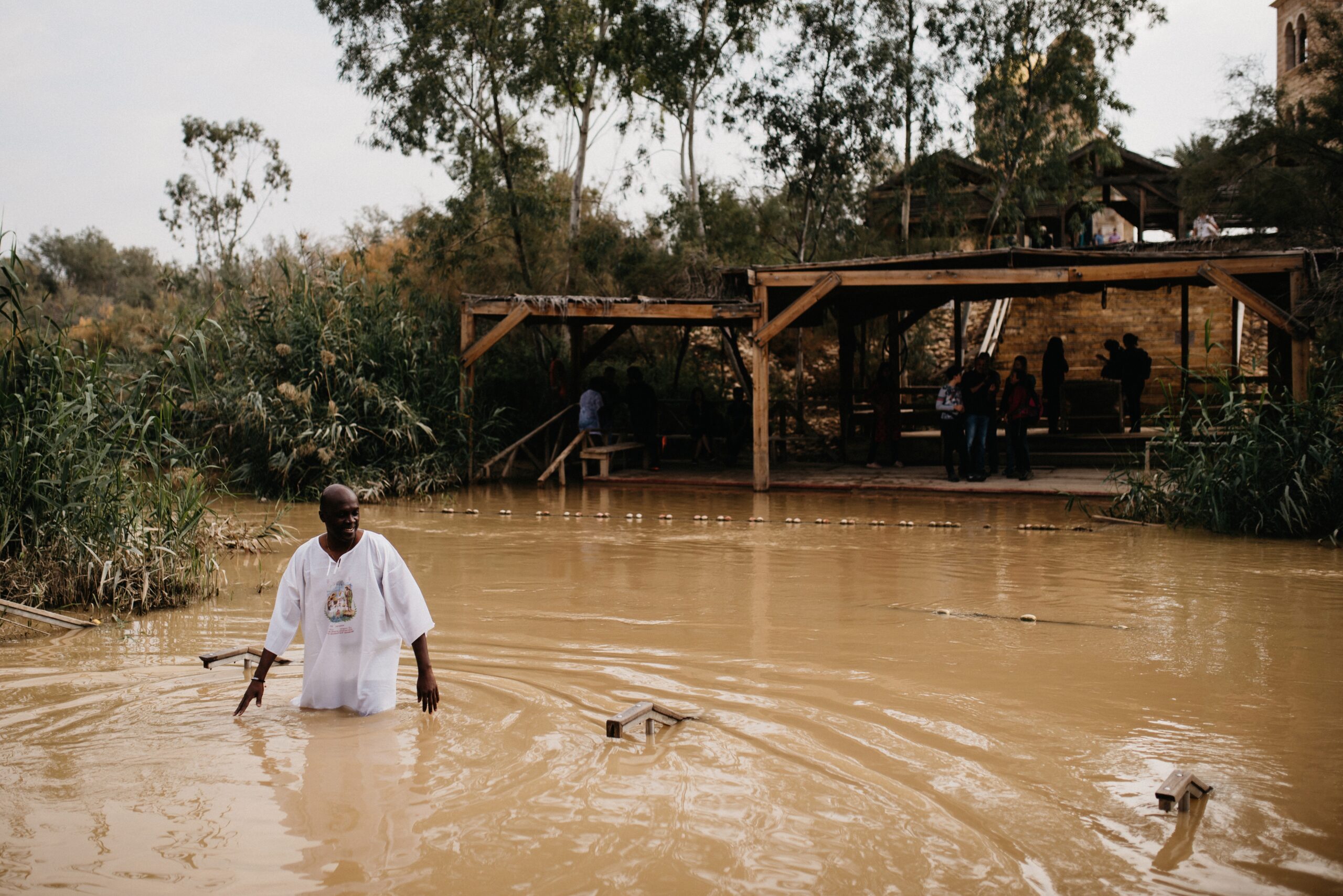 A pilgrim entering the Jordan River at Qasr al-Yahud