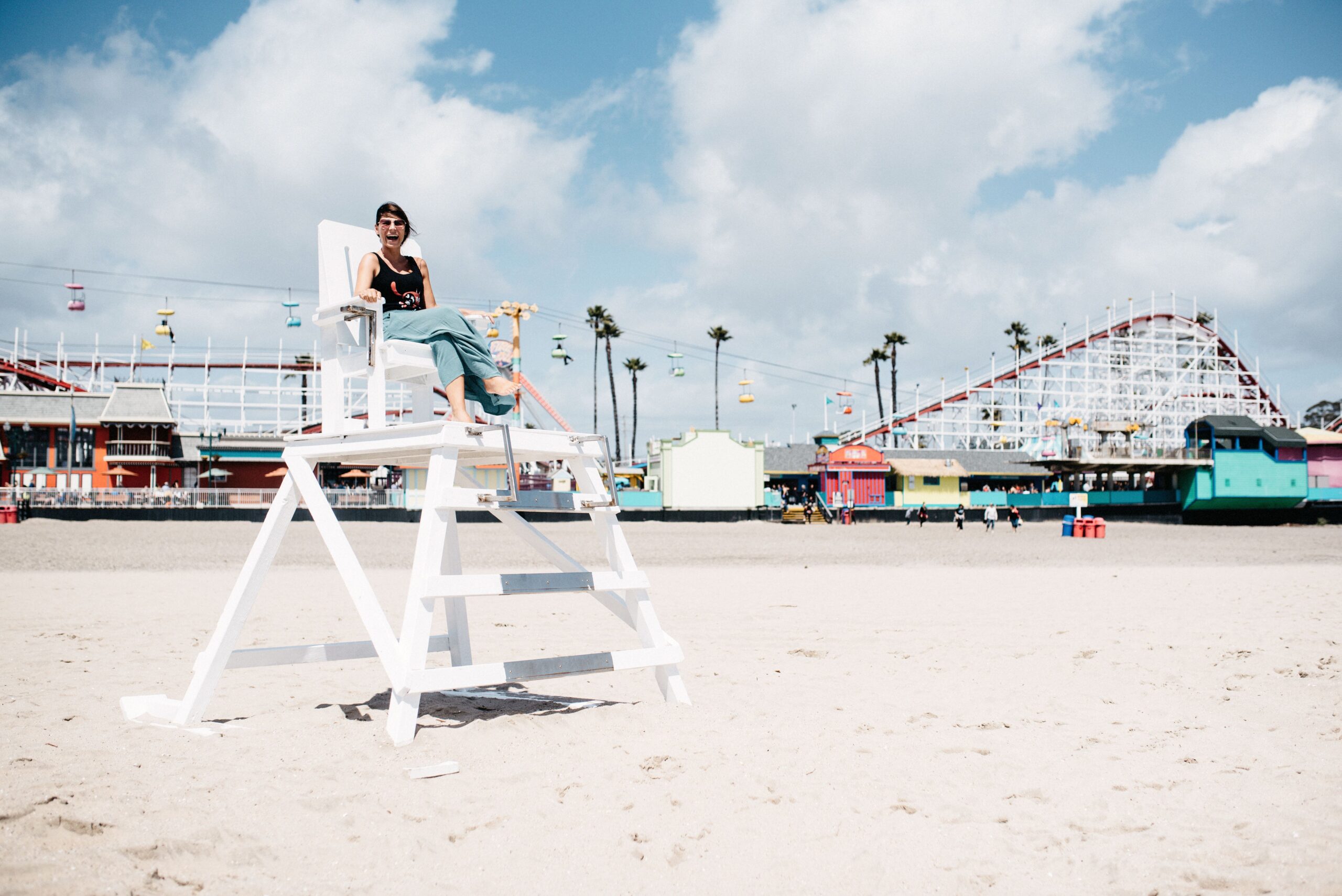 Bianca sitting on a lifeguard chair at Santa Cruz Beach Boardwalk