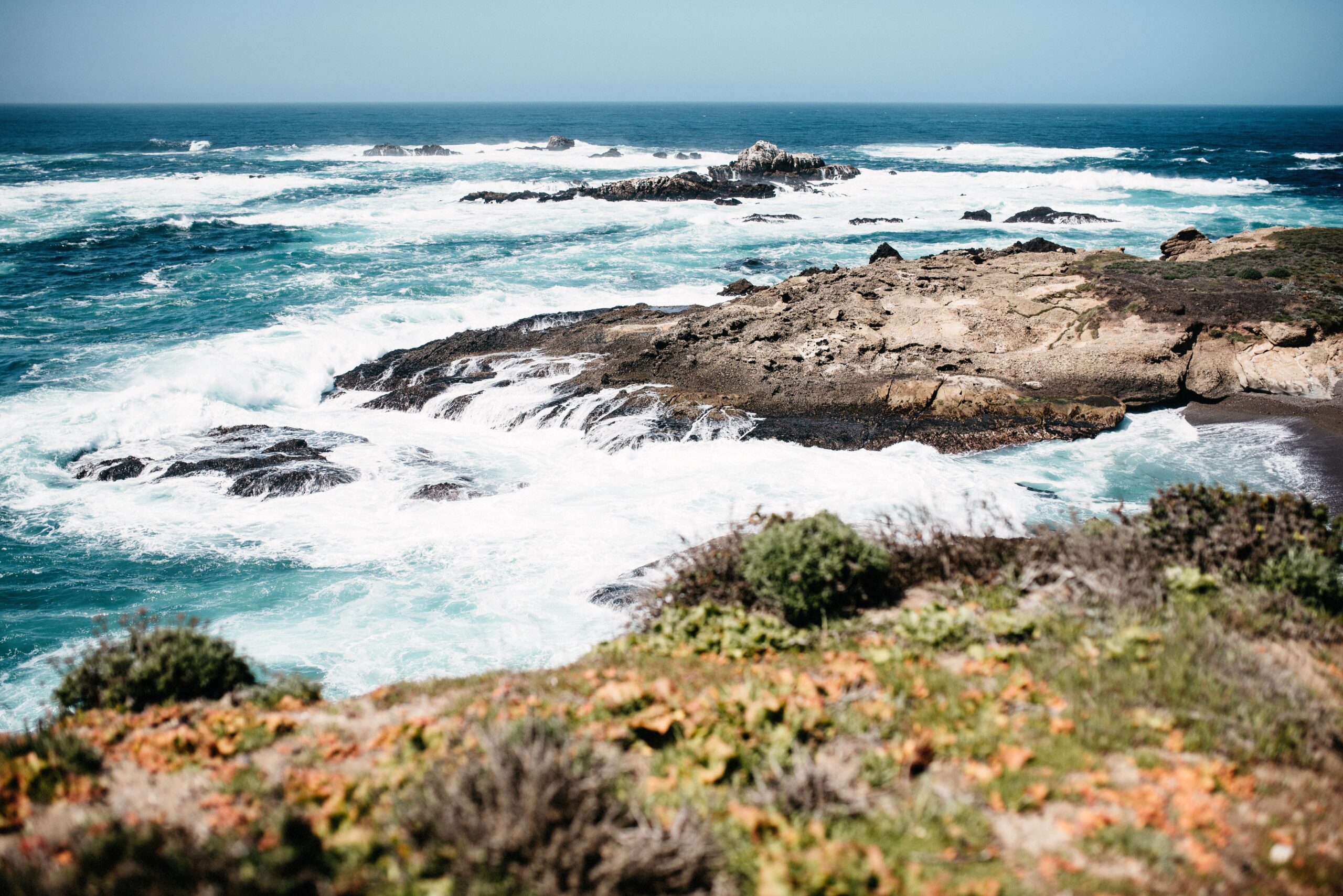Waves breaking across the rocky coastline at Point Lobos
