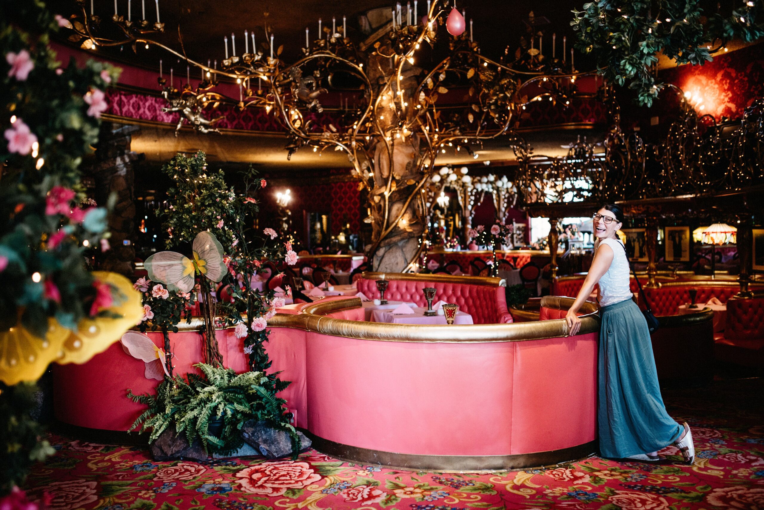 Bianca standing inside the pink dining room of the Madonna Inn