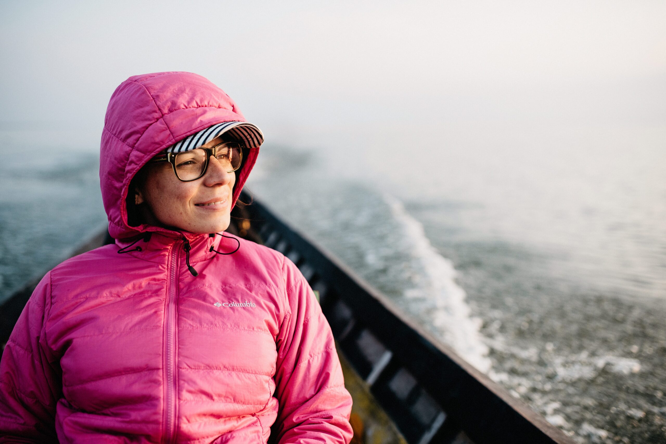 Bianca wrapped in a pink jacket during the cold morning boat ride