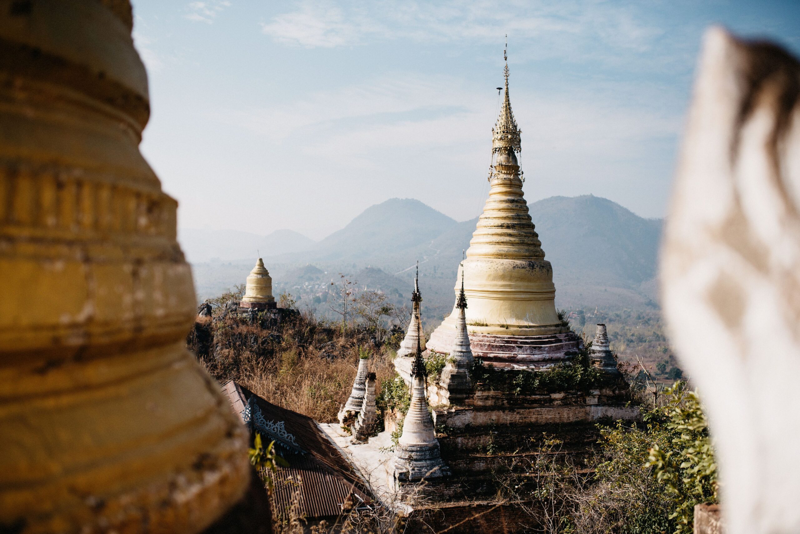 A white pagoda overlooking the fields and mountains near Indein