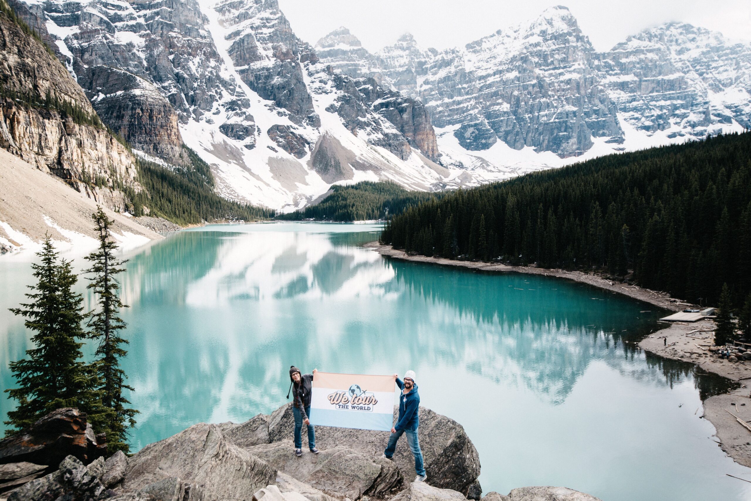 Moraine Lake reflecting the mountain peaks and remaining snow