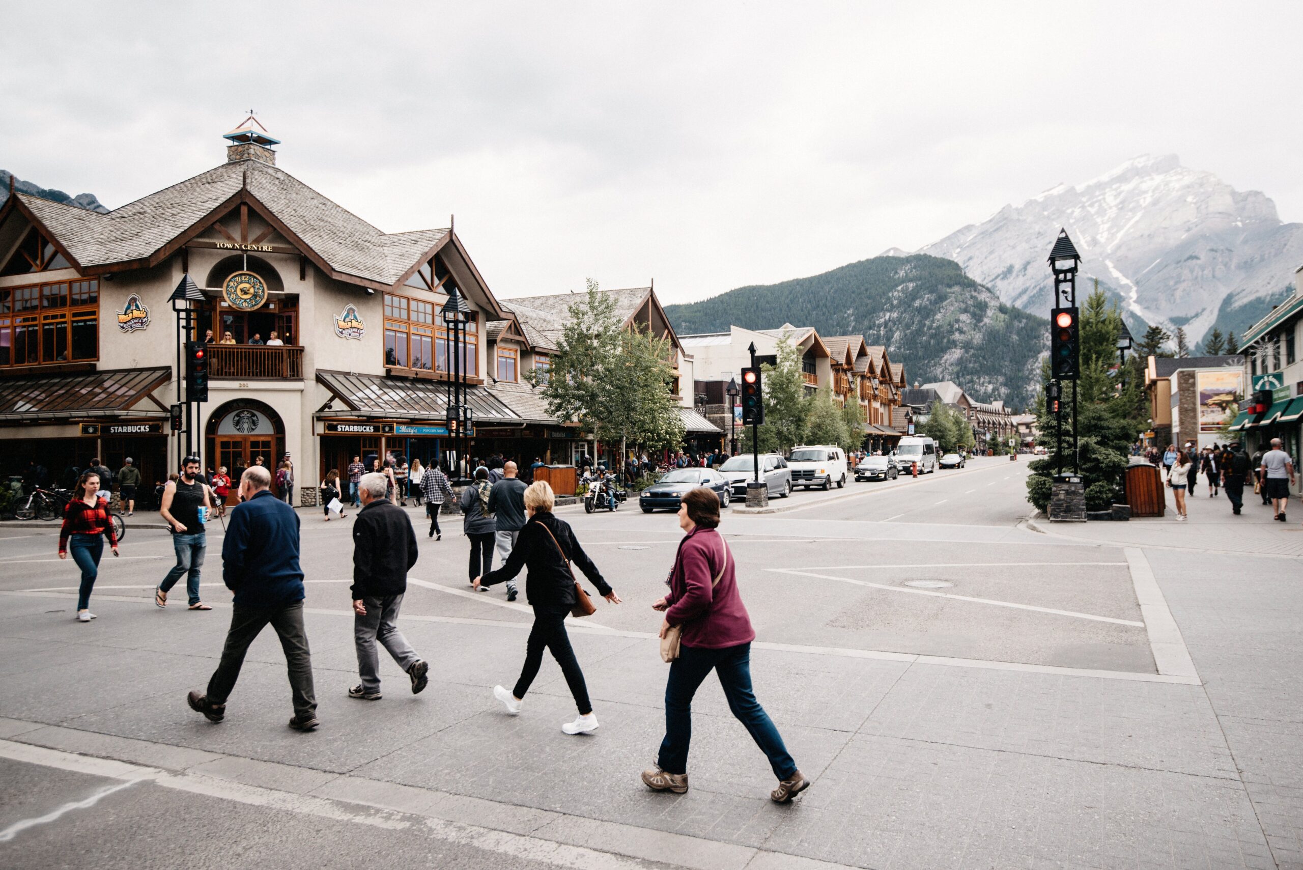 The main street of Banff with mountains behind the buildings