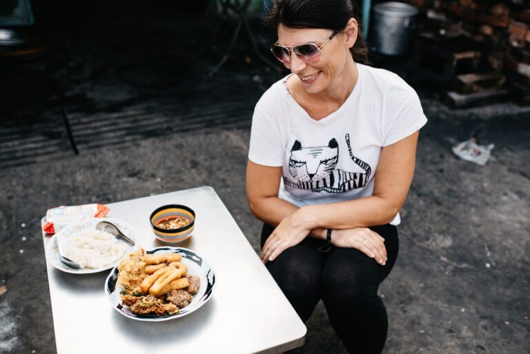 Bianca sitting beside a Burmese breakfast during a Mandalay food tour