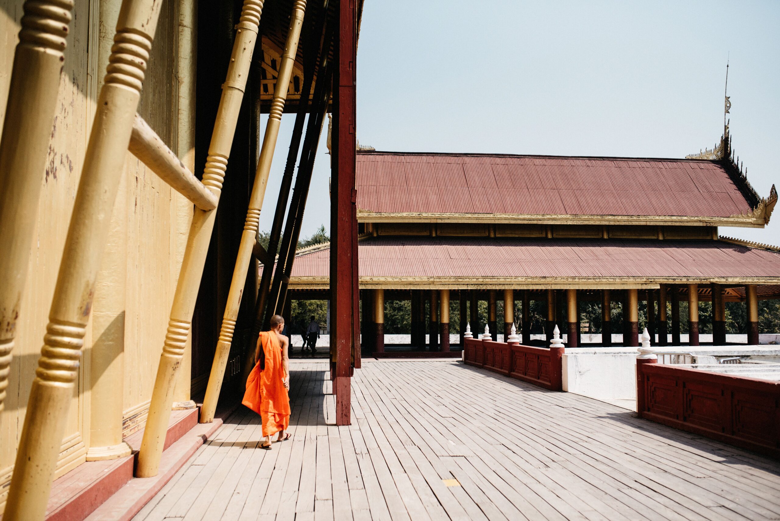 Bianca and Tom outside a wooden building in Mandalay's Royal Palace