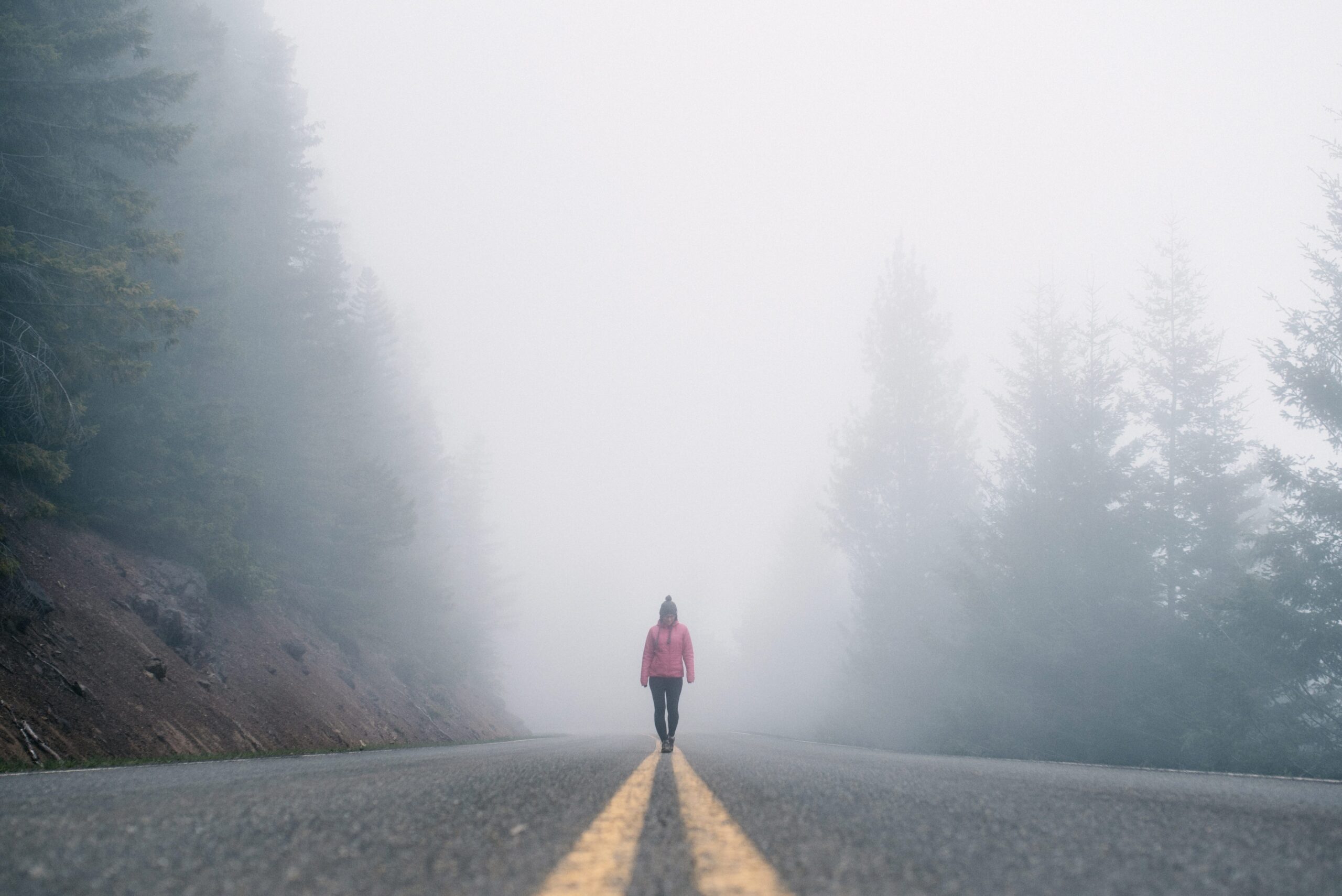 Bianca walking along a foggy road in Olympic National Park