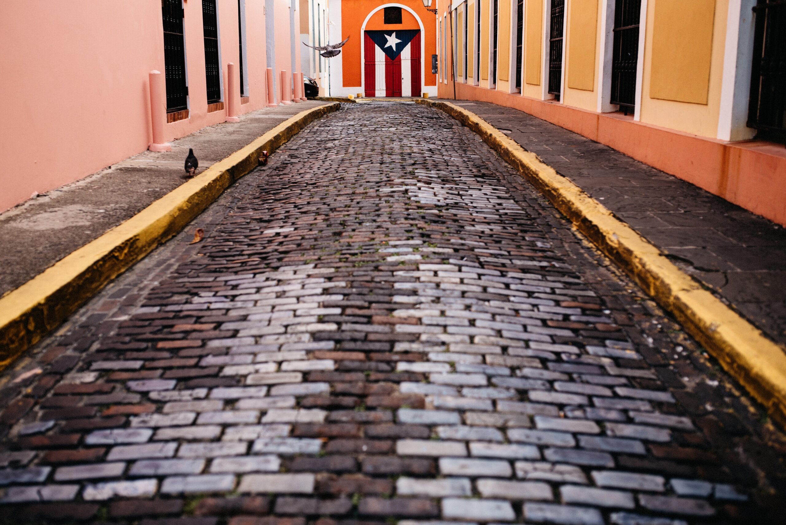 A low view along a colourful cobbled street in San Juan