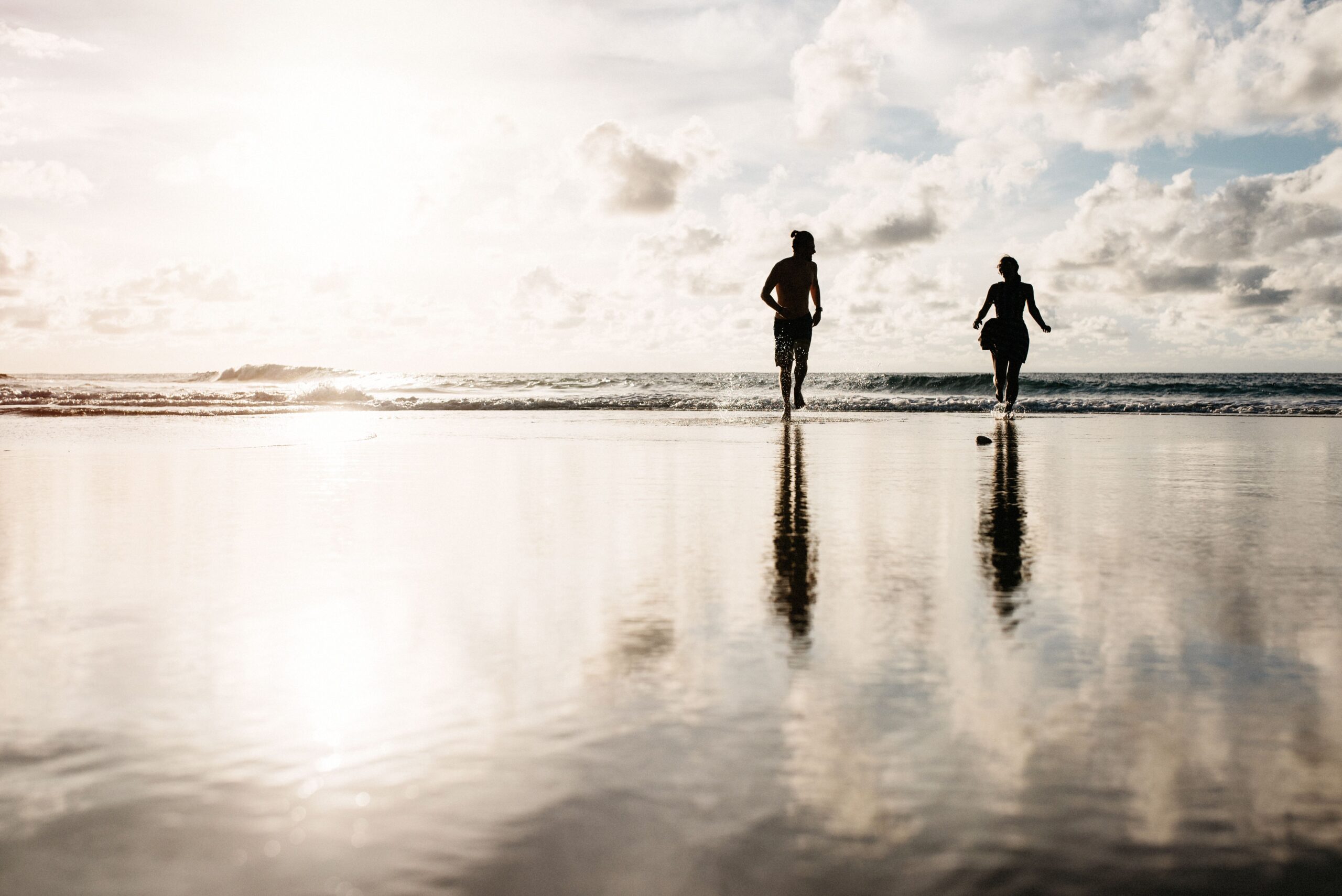 Bianca and Tom walking through shallow water on Puerto Rico's northwest coast