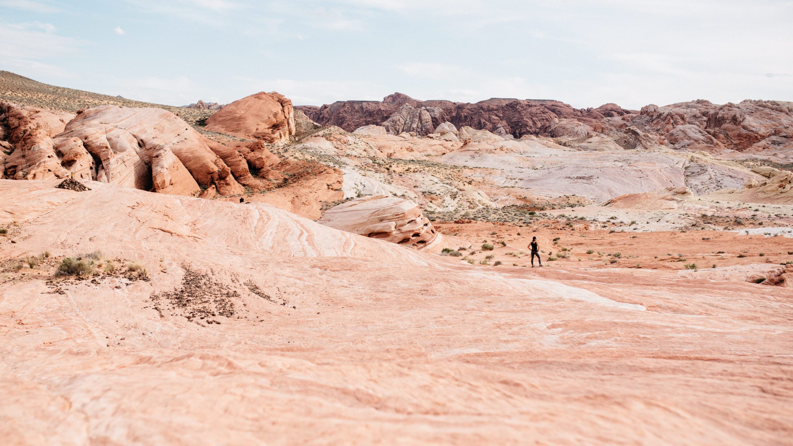 Bianca and Tom walking across striped sandstone
