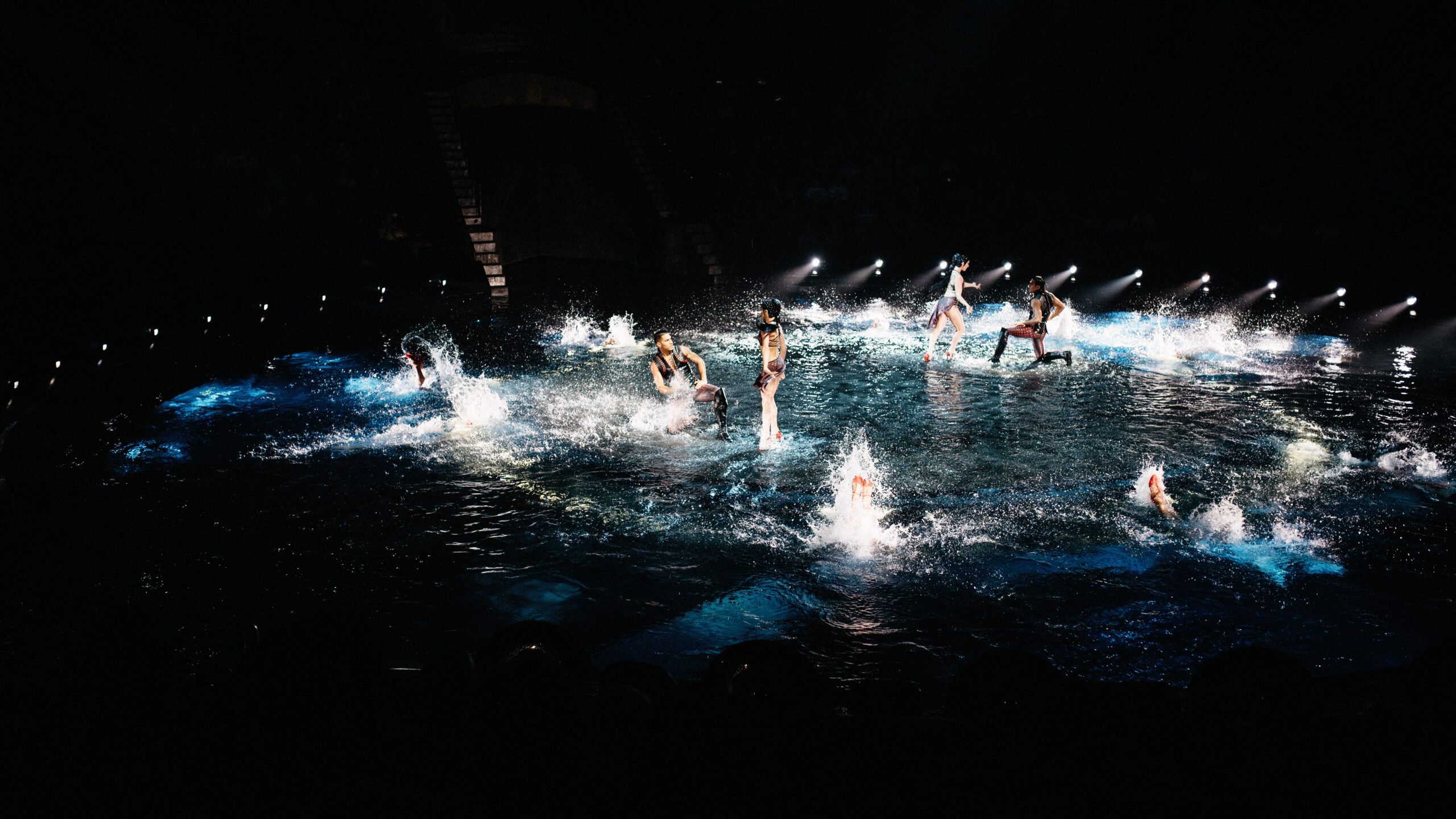 Performers moving through water during Le Rêve