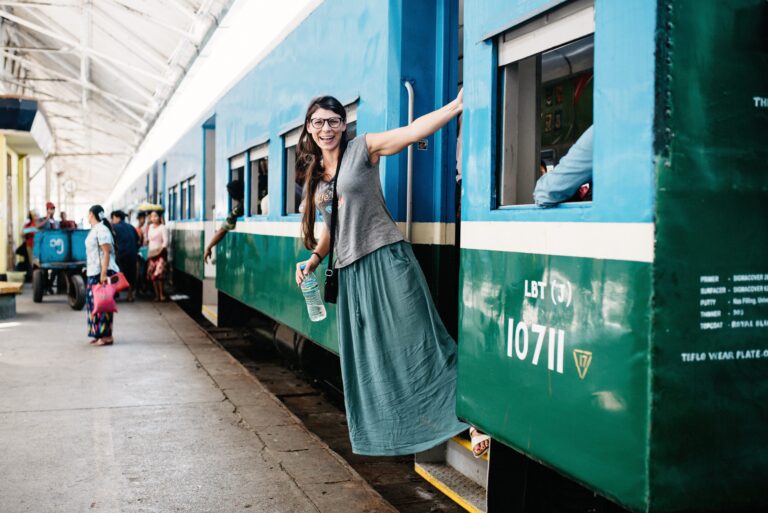 Bianca standing beside the Yangon Circular Train in Myanmar