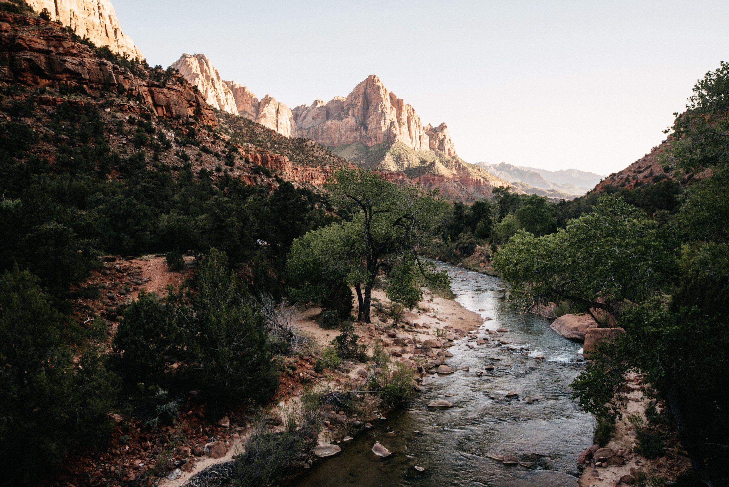 The Virgin River flowing beneath the cliffs of Zion