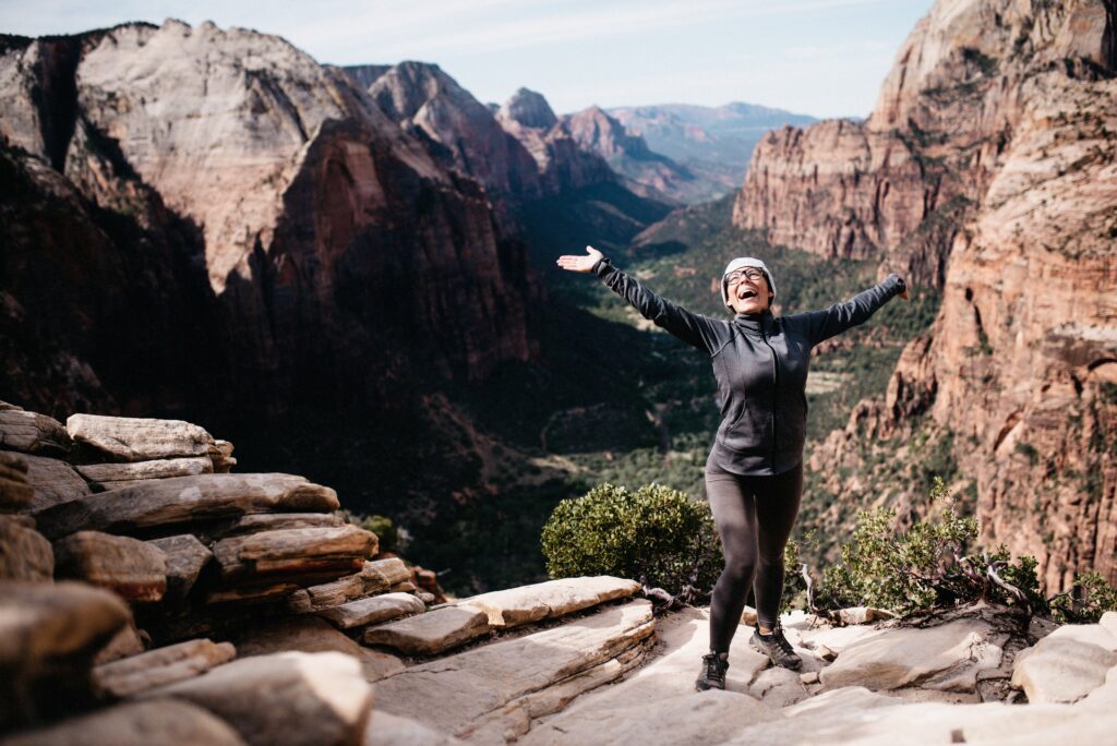 Bianca celebrating above Zion Canyon at the end of a steep hike